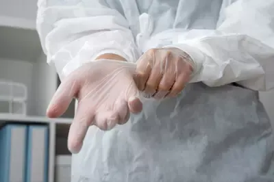 front-view-doctor-putting-gloves.webp