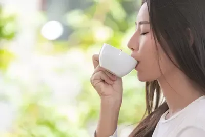 beautiful-woman-wearing-long-sleeved-white-shirt-sitting-coffee-shop