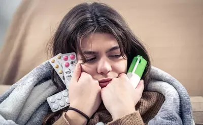 sick-young-woman-holding-cough-spray-pills-her-hands